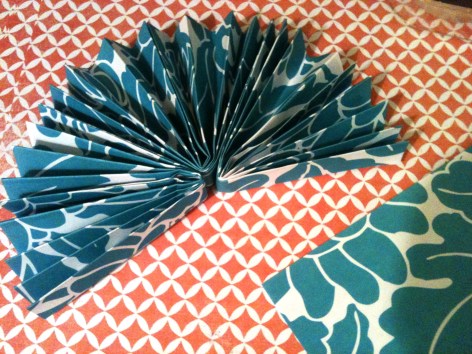 Tape all three folded squares together at ends